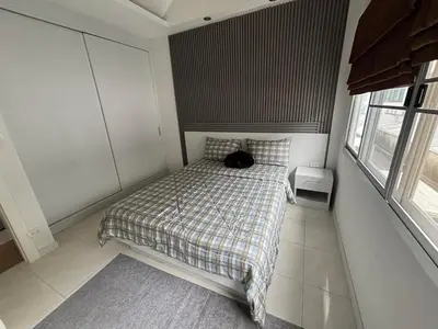 a black cat sitting on a bed in a bedroom at Laguna Townhouse with private pool and your own gym near Bangtao Beach in Laguna Phuket