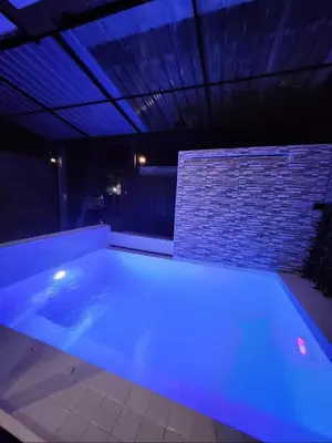 a swimming pool with blue lights in a house at Laguna Townhouse with private pool and your own gym near Bangtao Beach in Laguna Phuket