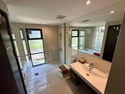 a bathroom with a sink and a large mirror at Apartment Title I, Rawai Phuket in Rawai Beach