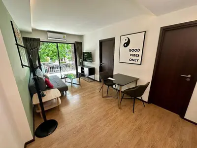 a living room with a couch and a table at Apartment Title I, Rawai Phuket in Rawai Beach