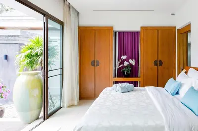 a bedroom with a large white bed and a window at Serene Contemporary Villa with a Swimming Pool in Ban Saiyuan (1)