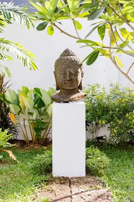 a statue of a head sitting on a white stand at Serene Contemporary Villa with a Swimming Pool in Ban Saiyuan (1)