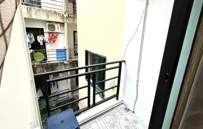 a balcony with a blue chair next to a building at Patong Easy Life 3 in Patong Beach