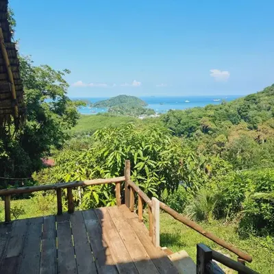 a wooden deck with a view of the ocean at Sea True Valley Phuket ซี ทรู วัลเลย์ ภูเก็ต in Ban Ao Makham