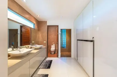 a bathroom with two sinks and a toilet at V210 Retreat 3BR Top of the Range, Sea View,Lift in Rawai Beach
