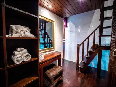 a room with a staircase and a desk and a mirror at Luxury 8 - 9 Bedroom Villa With 2 Pools in Kamala Beach