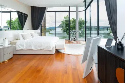 a bedroom with a bed and a desk with a computer at Zavaya Luxury Private Pool Villa Phuket in Layan Beach
