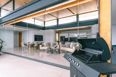 an open living room with a stove in the middle at Zavaya Luxury Private Pool Villa Phuket in Layan Beach