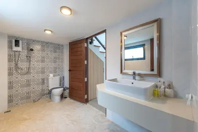 a bathroom with a sink and a toilet and a mirror at V212 One Of The Most Beautiful Villa In Phuket in Bang Tao Beach