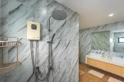 a shower in a bathroom with a marble wall at V212 One Of The Most Beautiful Villa In Phuket in Bang Tao Beach