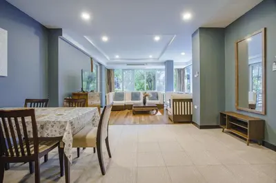 a dining room with a table and chairs and a living room at Karon View 2 Bed 5 Minutes walk to Karon Beach 11 in Karon Beach