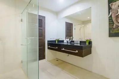 a bathroom with a glass shower and a sink at Karon View 2 Bed 5 Minutes walk to Karon Beach 13 in Karon Beach
