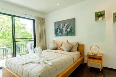 a bedroom with a bed with a white bird on it at Room in Rawai in Rawai Beach