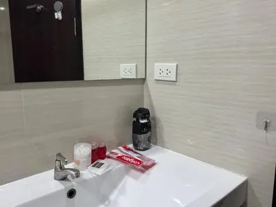 a bathroom with a white sink and a mirror at Room in Rawai in Rawai Beach