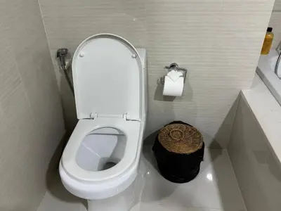 a bathroom with a white toilet with a trash can at Room in Rawai in Rawai Beach