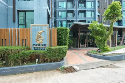a sign for a hotel in front of a building at C209 Surin Beachside Sun Escape & Infinity Pool in Surin Beach