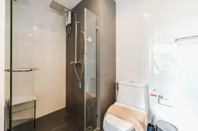 a bathroom with a shower and a white toilet at C209 Surin Beachside Sun Escape & Infinity Pool in Surin Beach