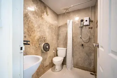 a bathroom with a toilet and a bath tub at ZJ House Phuket Town in Phuket Town