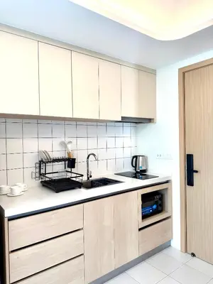 a kitchen with white cabinets and a sink at Brand new apartment on Kamala in Kamala Beach