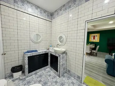 a bathroom with a sink and a mirror at Rawai House 16 in Ban Saiyuan (1)