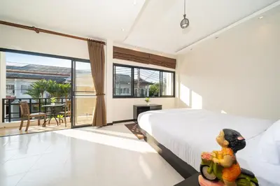 a bedroom with a large bed and a balcony at Laguna Townhouse with private pool, Bang Tao Beach in Laguna Phuket