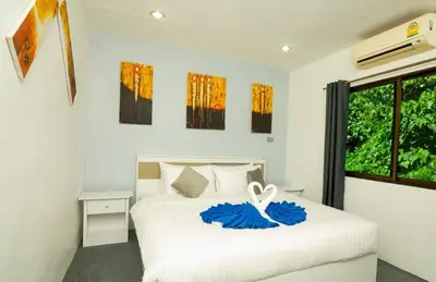 a bedroom with a white bed and a window at 3 Bed 3 Bath Villa 400m to Beach in Surin Beach