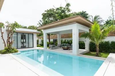 a swimming pool in the backyard of a house at Mouana Breeze Mai Khao 4-bedroom Pool Villa 9919 in Mai Khao Beach