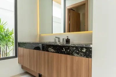 a bathroom with a sink and a mirror at Mouana Breeze Mai Khao 4-bedroom Pool Villa 9919 in Mai Khao Beach