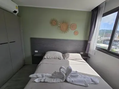 a bedroom with a bed with towels on it at Modern Retreat 1- BedT3-529 in Chalong