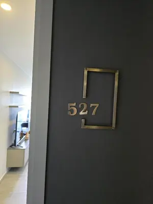 a door with a clock on the wall at Blue Edge Studio T3-527 in Chalong