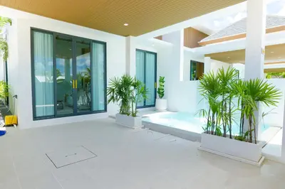 a house with a courtyard with plants in it at Relax Nai Yang beach pool Villas in Nai Yang Beach