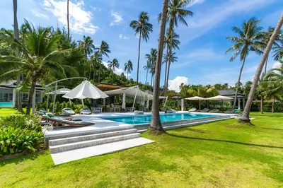 an image of a resort swimming pool with palm trees at Baan Klong IV in Ko Yao Noi