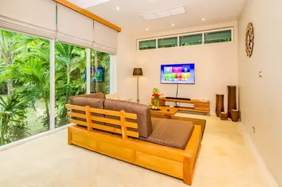 a living room with a couch and a tv at Baan Klong IV in Ko Yao Noi