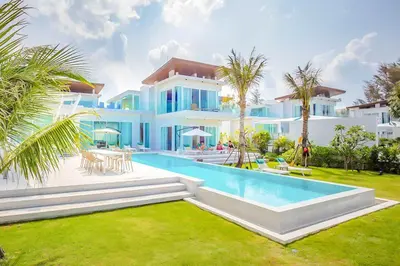 a large white house with a swimming pool in the yard at Baan Kloi III in Ban Na Tai