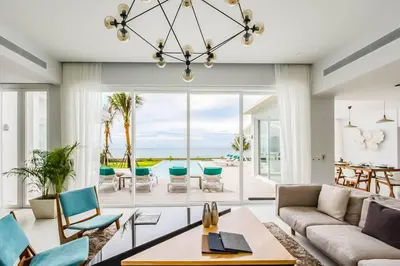 a living room with a couch and chairs at Baan Kloi III in Ban Na Tai