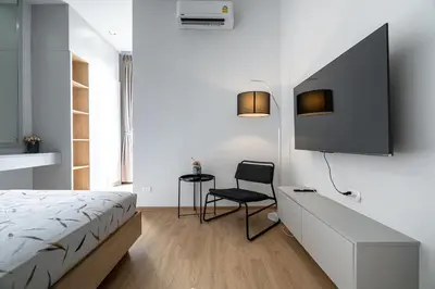 a bedroom with a bed and a desk and a chair at COMFORTABLE RENOVATED 2BR TownHouse5 MonkeyHill in Ban Sam Kong
