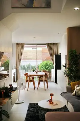 a living room with a table and a dining room at COMFORTABLE RENOVATED 2BR TownHouse5 MonkeyHill in Ban Sam Kong