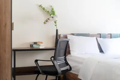 a bedroom with a desk and a chair next to a bed at Laguna Townhouse with Jacuzzi bathtub, Bang Tao beach in Laguna Phuket