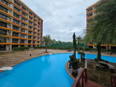 a large swimming pool in front of a building at 777 Beach Condotel in Mai Khao Beach