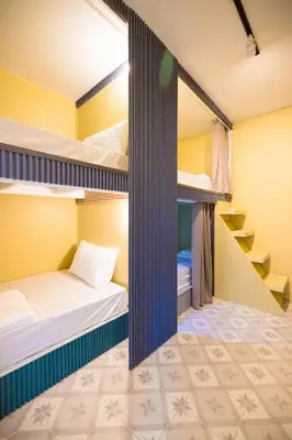 two bunk beds in a hostel room at 113 Yellow House Hostel in Phuket Town