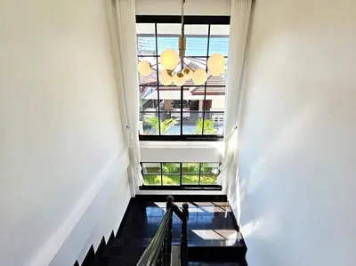a hallway with a large window and a staircase at 2 Bedroom Pool Villa in Kamala in Kamala Beach