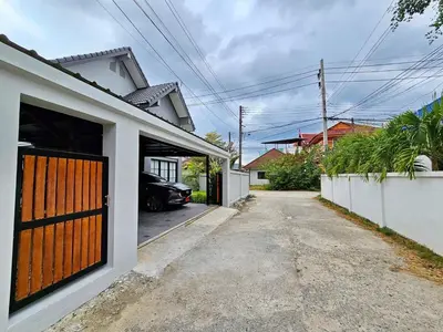a car is parked in the driveway of a house at 2 Bedroom Pool Villa in Kamala in Kamala Beach