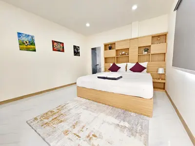 a bedroom with a large bed and a tv at 2 Bedroom Pool Villa Green View in Kamala Beach