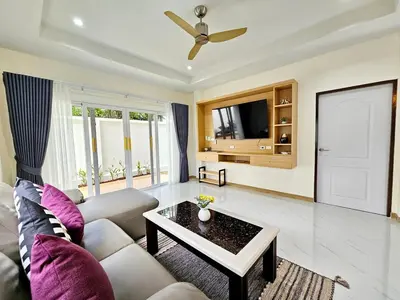 a living room with a couch and a table at 2 Bedroom Pool Villa Green View in Kamala Beach