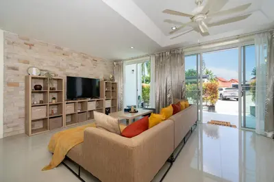 a living room with a couch and a tv at Sunny Paradise Kamala Beach in Kamala Beach