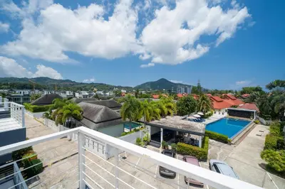 a view from the balcony of a house with a swimming pool at Sunny Paradise Kamala Beach in Kamala Beach