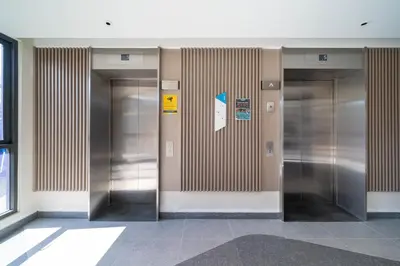 a row of metal elevators in a building at Skypark Laguna Garden View Bang Tao Beach in Laguna Phuket