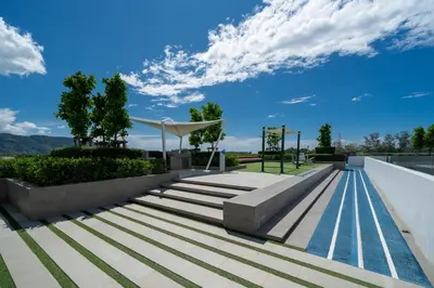 a swimming pool with stairs and a blue sky at Skypark Laguna Bang Tao Beach in Laguna Phuket
