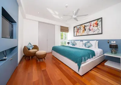 a bedroom with a bed and a flat screen tv at JSD Prime Property-Surin Beach in Surin Beach