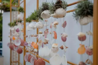 a bunch of paper shells hanging on a wall at Jampun Pool Villa in Klong Muang Beach
